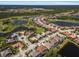 Panoramic aerial view captures homes near a golf course and lake, showcasing community layout and desirable location at 5270 White Ibis Dr, North Port, FL 34287