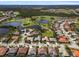 Expansive aerial view of a residential community featuring homes with pools, golf course, and scenic lakes at 5270 White Ibis Dr, North Port, FL 34287