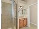 Bathroom featuring walk-in shower and vanity with sink and tiled floors at 5270 White Ibis Dr, North Port, FL 34287