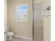 Bathroom featuring walk-in shower, toilet and shuttered window at 5270 White Ibis Dr, North Port, FL 34287