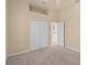 Spacious bedroom featuring plush carpeting and generous closet space at 5270 White Ibis Dr, North Port, FL 34287