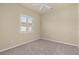 A bright, carpeted bedroom with a ceiling fan and a shuttered window at 5270 White Ibis Dr, North Port, FL 34287