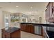 Well-designed kitchen with an island, stainless appliances, and views of pool and outdoor area at 5270 White Ibis Dr, North Port, FL 34287