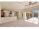 Open living area with tiled floors and sliding glass doors leading to an enclosed patio at 5270 White Ibis Dr, North Port, FL 34287