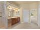 Bright primary bathroom featuring a large shower, wood vanity, and access to the bedroom at 5270 White Ibis Dr, North Port, FL 34287
