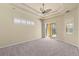 Large main bedroom showcasing a tray ceiling, ceiling fan, and access to the lanai at 5270 White Ibis Dr, North Port, FL 34287