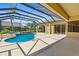 Inviting screened-in pool area with a sparkling pool and spacious patio at 5270 White Ibis Dr, North Port, FL 34287