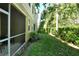 Private screened-in patio with green lawn and landscaping at 5450 Soapstone Pl # 9-103, Sarasota, FL 34233
