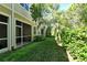 Serene screened-in patio overlooking a lush green lawn and beautifully landscaped backyard at 5450 Soapstone Pl # 9-103, Sarasota, FL 34233