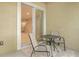 Balcony view looking into open sliding glass door toward living room table and chairs on patio at 5450 Soapstone Pl # 9-103, Sarasota, FL 34233