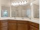 Bright bathroom featuring double vanity, mirror, and glass shower at 5450 Soapstone Pl # 9-103, Sarasota, FL 34233