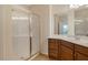 Modern bathroom with glass shower and wooden vanity at 5450 Soapstone Pl # 9-103, Sarasota, FL 34233