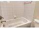 Clean bathroom featuring a white tiled tub and shower combination at 5450 Soapstone Pl # 9-103, Sarasota, FL 34233