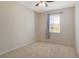 This bedroom features neutral colored walls, neutral carpet, a ceiling fan and a window with blinds at 5450 Soapstone Pl # 9-103, Sarasota, FL 34233