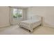 Cozy bedroom with window view and a patterned bed at 5450 Soapstone Pl # 9-103, Sarasota, FL 34233