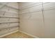 Spacious walk-in closet featuring extensive wire shelving for storage at 5450 Soapstone Pl # 9-103, Sarasota, FL 34233