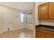 Open dining area features wood cabinets, tile floors, and window at 5450 Soapstone Pl # 9-103, Sarasota, FL 34233