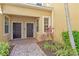 Townhome entrances with well-maintained landscaping and a brick pathway at 5450 Soapstone Pl # 9-103, Sarasota, FL 34233