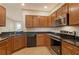 Traditional kitchen design featuring granite counters, wooden cabinets and stainless steel appliances at 5450 Soapstone Pl # 9-103, Sarasota, FL 34233