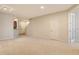 Spacious living room with neutral carpet, recessed lighting, and adjacent kitchen space at 5450 Soapstone Pl # 9-103, Sarasota, FL 34233
