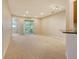 Bright living room with carpet, recessed lighting, and access to the patio at 5450 Soapstone Pl # 9-103, Sarasota, FL 34233
