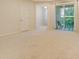Bright living room with neutral carpet and sliding glass doors leading to a patio at 5450 Soapstone Pl # 9-103, Sarasota, FL 34233