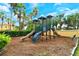 Community playground with slides, climbing structures, and lush greenery, perfect for Gathering fun at 5450 Soapstone Pl # 9-103, Sarasota, FL 34233