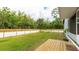 Spacious backyard features a wooden deck, well-maintained lawn, and privacy fence, offering ample outdoor space at 5671 Osprey Rd, Venice, FL 34293