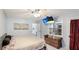 Well lit bedroom featuring a TV, seating area and large windows, and bathroom access at 5671 Osprey Rd, Venice, FL 34293