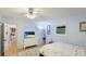 Bright bedroom with a TV, soft carpet, and natural light from the window at 5671 Osprey Rd, Venice, FL 34293