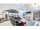 Open living room and kitchen with bar seating, stainless appliances, stone countertops, and modern finishes at 5671 Osprey Rd, Venice, FL 34293