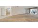 Spacious living room featuring neutral carpet, access to a screened lanai, and abundant natural light at 5806 New Paris Way, Ellenton, FL 34222