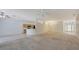 Open living space with carpet, tile flooring, breakfast bar, kitchen area, and foyer with glass entry doors at 5806 New Paris Way, Ellenton, FL 34222