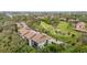 Aerial view of community featuring lush greenery, golf course, and multi-story residential buildings at 6002 Oak Creek Ln # 1925, Bradenton, FL 34210
