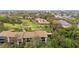 Aerial view showcasing the condo complex set against a backdrop of golf course and lush trees at 6002 Oak Creek Ln # 1925, Bradenton, FL 34210