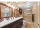 Well-lit bathroom features a double sink vanity and a glass-enclosed shower at 6002 Oak Creek Ln # 1925, Bradenton, FL 34210