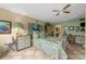 Relaxing bedroom with a floral comforter, neutral walls and tile flooring at 6002 Oak Creek Ln # 1925, Bradenton, FL 34210