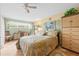 Cozy bedroom featuring a comfortable bed, dresser, and ample natural light at 6002 Oak Creek Ln # 1925, Bradenton, FL 34210
