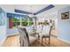 Inviting dining room with a glass table, seating for six, and views of the lush outdoor greenery at 6002 Oak Creek Ln # 1925, Bradenton, FL 34210