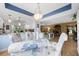Open-concept space blending dining room and kitchen featuring a glass table and plenty of natural light at 6002 Oak Creek Ln # 1925, Bradenton, FL 34210