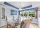 Bright dining area with glass table, blue accents, and large windows showcasing lush greenery at 6002 Oak Creek Ln # 1925, Bradenton, FL 34210