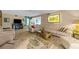Spacious living room featuring wood-look tile flooring and a comfortable beige sectional sofa at 6002 Oak Creek Ln # 1925, Bradenton, FL 34210