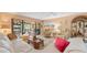 Comfortable living room with neutral color palette, plush seating, and sliding glass doors at 6002 Oak Creek Ln # 1925, Bradenton, FL 34210