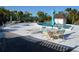 Enjoy the beautiful pool with lounge chairs and seating under the shade of a blue umbrella at 6002 Oak Creek Ln # 1925, Bradenton, FL 34210
