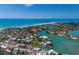 Scenic aerial view of a waterfront residential area, canal front homes, beautiful waterways, and white sand beaches at 619 Bayview Dr, Longboat Key, FL 34228