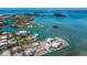 Gorgeous aerial shot displays coastal real estate with private docks, water access, and tropical islands in background at 619 Bayview Dr, Longboat Key, FL 34228