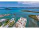 Aerial shot featuring luxurious waterfront homes with swimming pools, boat access, and surrounding waterways with small islands at 619 Bayview Dr, Longboat Key, FL 34228