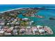 Picturesque aerial scene showcases luxurious waterfront homes, boat docks, lush landscaping and community waterways at 619 Bayview Dr, Longboat Key, FL 34228