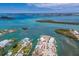 Overhead view showcasing coastal community with waterfront properties, boat docks, and lush green islands in the waterway at 619 Bayview Dr, Longboat Key, FL 34228
