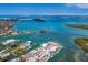 Expansive aerial view captures the waterfront community, featuring canals, coastal homes, islands, and boating opportunities at 619 Bayview Dr, Longboat Key, FL 34228
